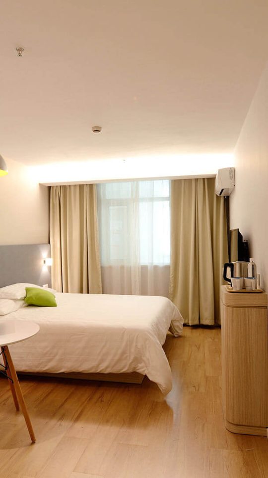 a hotel room with two beds and a desk at The Senara