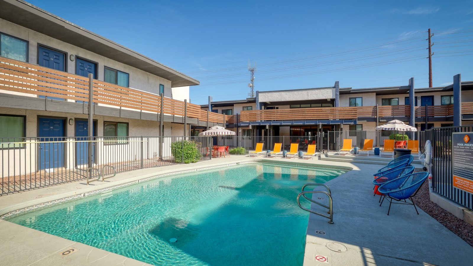 a pool and lounge chairs at an apartment complex at The Senara