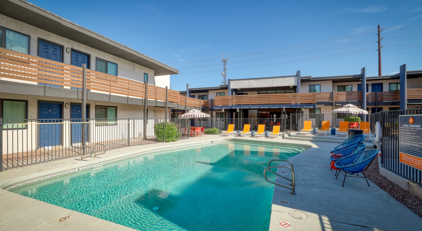 a pool and lounge chairs at an apartment complex at The Senara