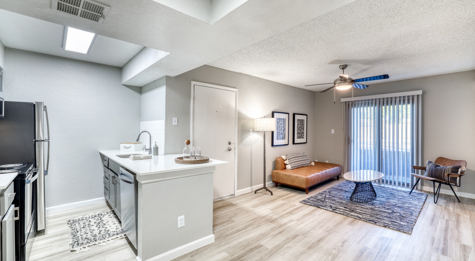 the living room and kitchen area of a two bedroom apartment at The Senara