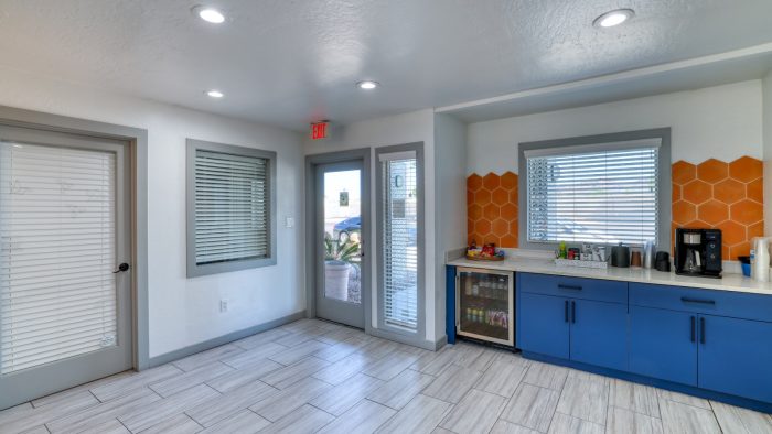 a kitchen with blue cabinets and orange counter tops at The Senara