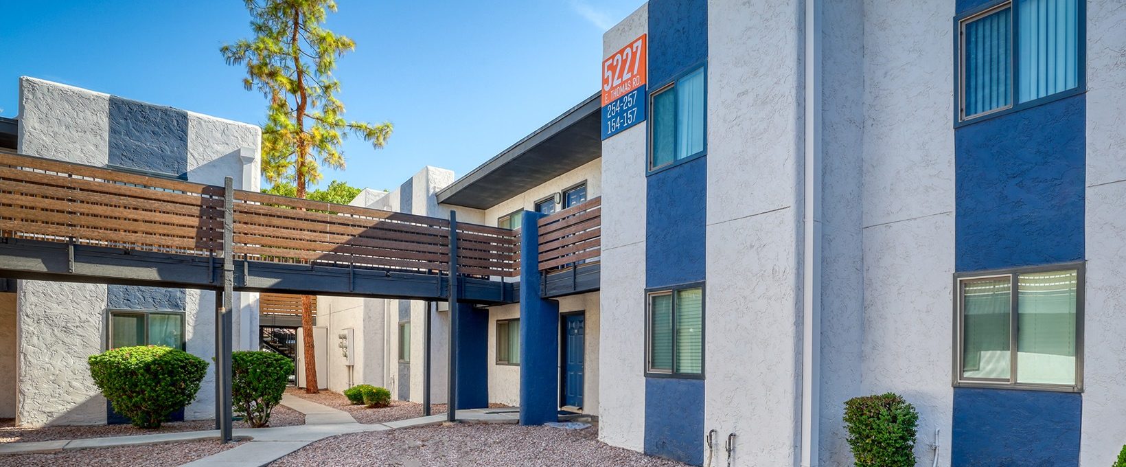 the exterior of an apartment building with blue and white siding at The Senara