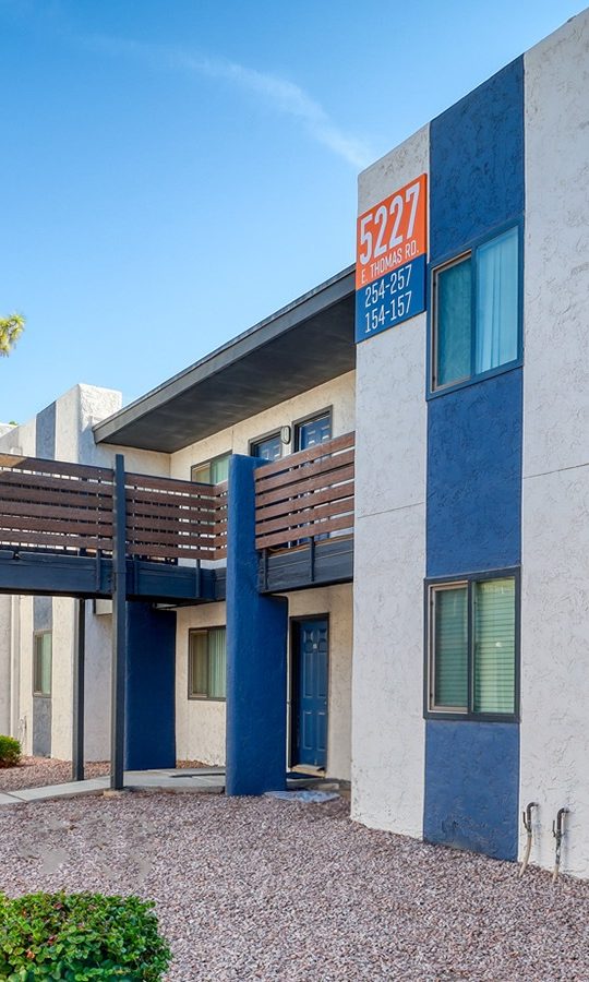 the exterior of an apartment building with blue and white siding at The Senara