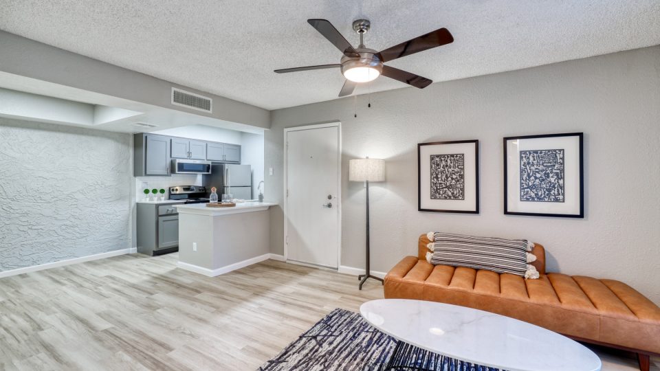 a living room with a ceiling fan and a couch at The Senara
