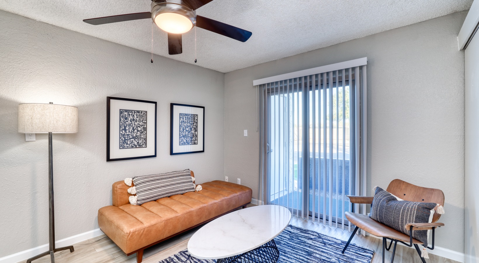 a living room with a ceiling fan and a couch at The Senara